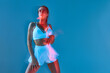 © Georgii - Beauty white woman stylish portrait in sports underwear on blue background. Girl posing with beautiful body. Long exposure effect.