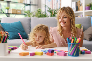 Wall Mural - Girl and mother drawing together at home