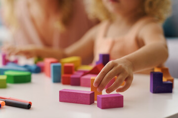 child playing with wooden blocks