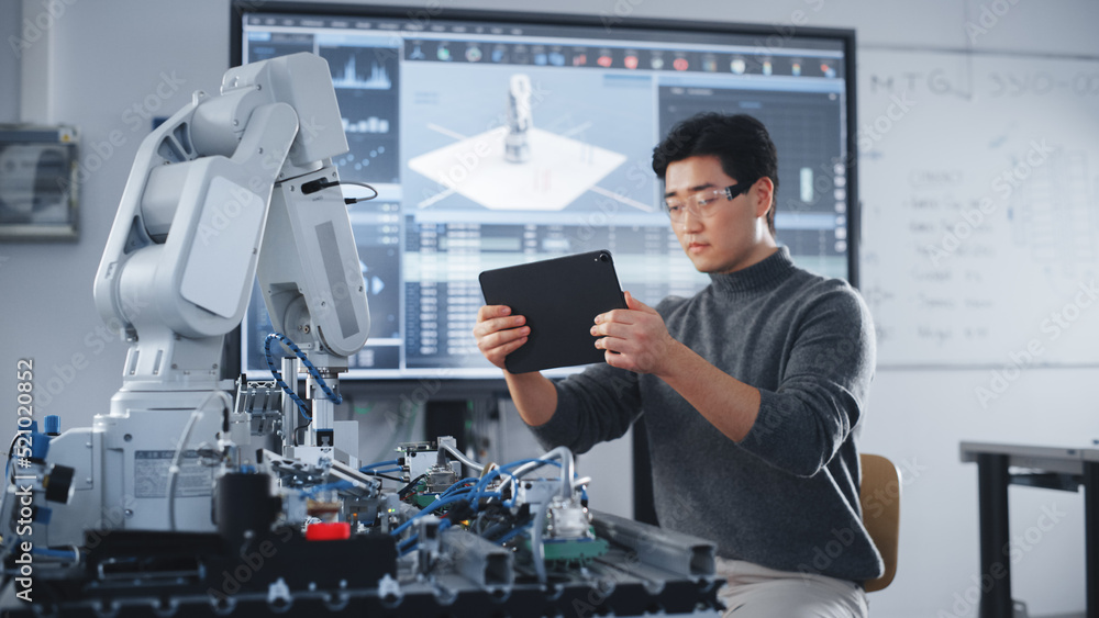 Student Holding Tablet and Controlling Robot Hand Moving at Different ...