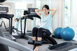 © Puwasit Inyavileart - Beautiful and shapely Asian woman working out in the gym, Play exercise machine treadmill, Dumbbell, stretching, Hanging bar, Barbell, Cardio, Stretch, Woman warming up in the gym, Jump rope.