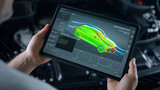 Fototapeta  - Mechanic engineer holding a digital tablet with engineering research software application on the screen, aerodynamic test of parameters data in the wind tunnel of an eco-friendly car body