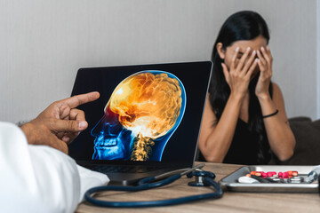 Wall Mural - Doctor showing a x-ray of pain in the brain on a laptop. Migraine Headache