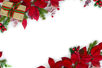 christmas decoration. frame of gift boxes, red poinsettia flowers, christmas tree branch, red berrie