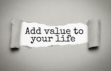 ADD VALUE TO YOUR LIFE - Text On Torn Paper On White Desk In Sunlight.