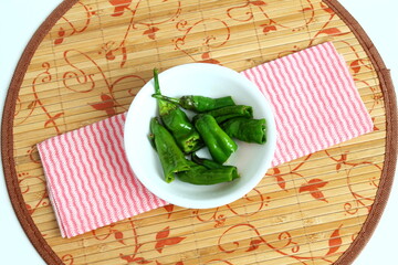 indian gujarati style chili or chilli pepper marinated and stir fry for preserving and pickle can serve with indian gujarati snack fafda,gathiya,pakoda,khaman and other food