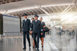 © Friends Stock - Pilots and stewardesses in uniform walking through the airport terminal