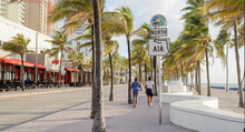 Two People Walking On North A1a Sign In Ft Lauderdale Beach Florida 