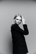 © SHOTPRIME STUDIO - Charming young professional model puts her hand to her face cheek in the studio. The concept for the new collection. Classic black and white photo
