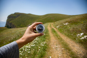 Wall Mural - A male is looking for a compass in the mountains