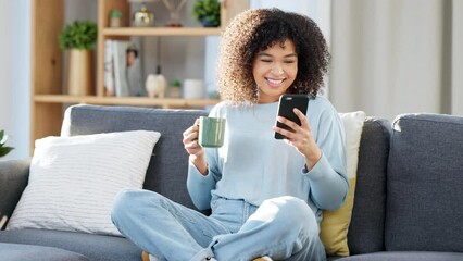 Poster - Woman reading a text message on a phone, scrolling on social media online or browsing an app while drinking coffee at home. One happy, smiling and comfy black female searching the web with tea