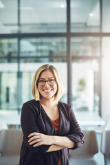 Wall Mural - Confident manager, leader and creative boss with her arms crossed in a powerful, assertive and proud stance. Portrait of smiling, happy and business woman ready for success with arms folded in office