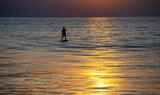 Fototapeta  - stand up paddle board sunset 