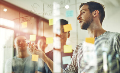 Aufkleber - Group of young designers brainstorm as a team. Writing down new ideas on glass board inside workplace together. Business people meeting at the office to discuss notes and share creative designs.