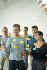 Poster - Confident manager, leader or boss talking in a meeting, workshop or presentation with sticky notes in the boardroom. Businessman talking, discussing and brainstorming with a group of colleagues