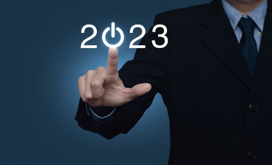 Wall Mural - Businessman pressing 2023 start up business flat icon over light blue background, Business happy new year 2023 cover concept