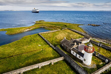 Old Lighthouse On Mutton Island And Luxury Cruise Ship In Galway Bay. Travel And Tourism Concept. Blue Cloudy Sky. Galway City, Ireland. Aerial Image.