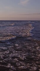 Wall Mural - Large foamy waves at high tide, drone video