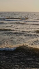 Wall Mural - Large foamy waves at high tide, drone video