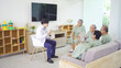 © tampatra - An Asian doctor talking to a group of old elderly patient or pensioner people smiling, relaxing, having fun together in nursing home. Senior lifestyle activity recreation. Retirement. Health care
