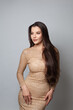 © millaf (Nemchinova) - Lovely fashionable woman brunette wearing golden evening gown on white background