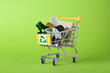 Leinwandbild Motiv Shopping cart with recycling symbol full of garbage on light green background