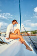 © Georgii - Fashion lifestyle portrait of young brunette woman in the sexy swimsuit posing at white luxury yacht