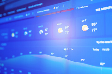 Weather forecast interface on a digital display showing hot weather for the next days.Selective focus.
