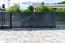 Modern Panel Fencing In Anthracite Color, Visible Sliding Gate To The Garage As Well As A Handle And A Lock.