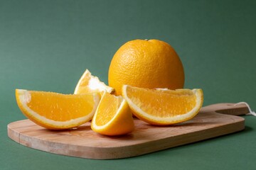 Poster - Closeup of cut oranges on the wooden board.