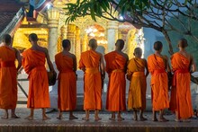 Number Of Buddhist Monks In The Morning Begging For Alms In Luang Prabang, Laos