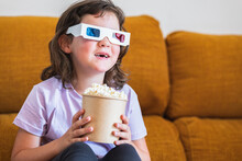 Girl In 3D Glasses With Popcorn Watching Movie