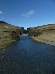 Vertical shot of a river flowing through Fjadrargljufur Canyon in Iceland