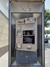 Broken Public Phone. Telephone Box Damaged On The Street Due To Vandalism