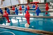 A row of players in a table football with selective focus on one red player
