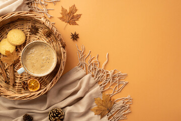 Wall Mural - Autumn concept. Top view photo of wicker tray with cup of coffee cinnamon sticks cookies dried orange slice anise yellow maple leaves scarf and pine cones on isolated orange background