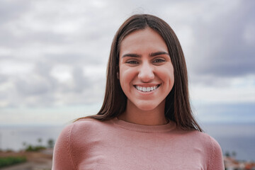 Young teenage girl smiling on camera outdoor