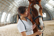 © standret - Medical worker. Female doctor in white coat is with horse on a stable