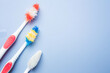 © Parkin - Used old toothbrush on blue background. Dental care concept. copy space
