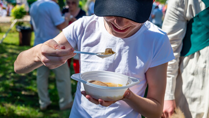 Volunteers distribute food to the poor outdoors, selective focus