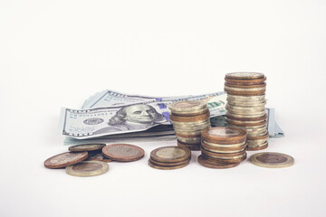 Stack of coins and banknotes isolated on white background. Concept of corporate business economy and financial growth by investment.