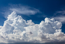 Closeup Of Billowy Cumulus Clouds. Wispy Clouds, Deep Blue Sky In Background. 
