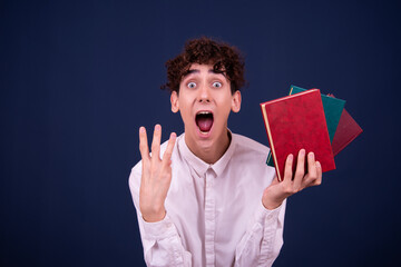 Surprised young attractive student is reading a book.	