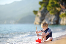 Joyful Boy Have Fun During A Beach Holiday By The Clear Warm Sea