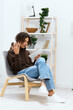 © SHOTPRIME STUDIO - portrait of a man writes in a notebook sitting on a chair in the room isolated background