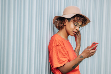 Canvas Print - hipster girl with mobile phone and hat on the street