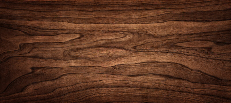 Wall Mural - Walnut tree texture close up. Wide walnut wood texture background. Walnut veneer is used in luxury finishes.
