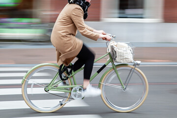 Wall Mural - woman rides a bicycle in the city