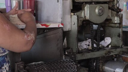 Canvas Print - Male making tortilla in a machine in Mexico