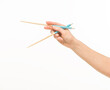 © serhii - hand holding chopsticks on white background isolated